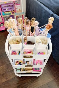 several barbie dolls are arranged on a cart