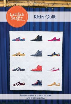 a quilted wall hanging on the side of a building with shoes in different colors