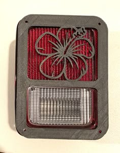 a close up of a red light on a white wall