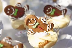 several desserts are arranged in small glass dishes on a table with white and green decorations