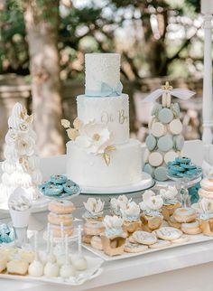 a table topped with lots of cakes and cupcakes