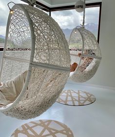 two hanging chairs in the middle of a room