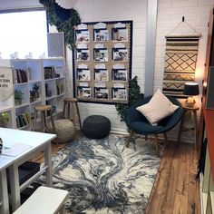 a living room filled with furniture and bookshelves next to a wall mounted book shelf