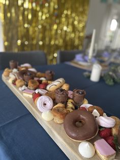 a table topped with lots of donuts and other pastries on top of it