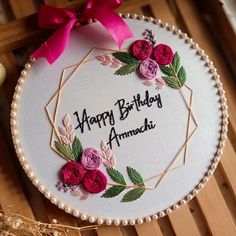 a birthday cake decorated with flowers and the words, happy birthday ammachi on it