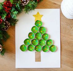 a christmas tree made out of cupcakes sitting on top of a piece of paper