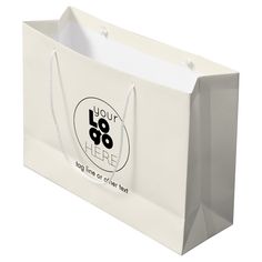 a white shopping bag with the words, you're 80 here on it and an oval sticker