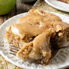 there is a piece of apple pie on the plate with a fork in front of it