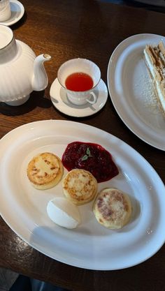 there is a piece of cake on the plate next to other plates with pastries