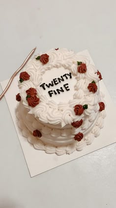 there is a white cake with red roses on it and the words twenty five written in black