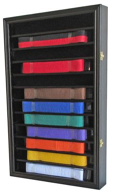 a rack with many different colored belts in it