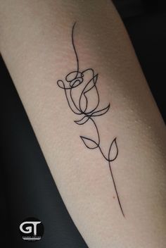 a small tattoo on the arm of a woman's left arm, with a single flower