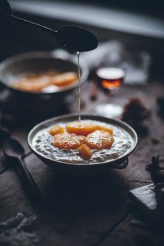 a person pouring syrup on food in a bowl