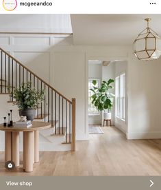 the interior of a house with white walls and wood flooring is featured in this image