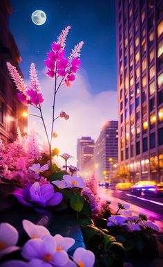 purple flowers are in the foreground with tall buildings and street lights behind them at night