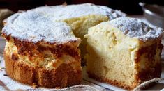 a cake that has been cut into pieces and is sitting on a table with a piece missing from it