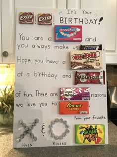 a birthday sign with candy bars and candies on it