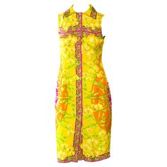 This Versace take on a collared 'ladies who Donatella Versace designed lunch' dress. This dress by Gianni Versace for the Spring/Summer 2000 collection includes an orchid jungle motif, similar to Donatella's famous jungle print on JLo and other items from that season's runway. The primarily yellow and orange dress is sleeveless and features crystal buttons from top to bottom on the front of the garment. The dress also features a classic Greek key pattern in pink and a large Versace Medusa logo o Lunch Dress, Versace Design, Lunch Dresses, Ladies Who Lunch, Versace Dress, Versace Couture, Greek Key Pattern, Crystal Buttons, Donatella Versace