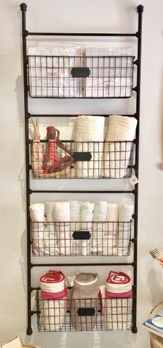 the shelves are organized with baskets and toilet paper