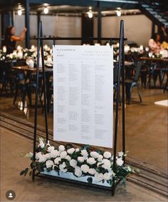 the seating chart is set up on an easel for guests to sit down at