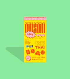 a carton of masoom larb thai tea on a green background with shadow