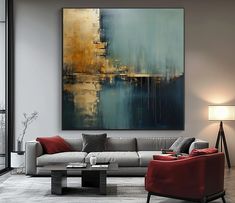 a living room filled with furniture and a large painting on the wall above it's couch