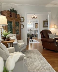 a living room filled with furniture and a dog sitting in the middle of the room