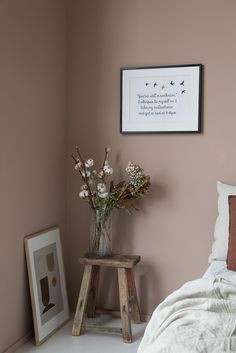 a bedroom with pink walls and white bedding