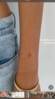 a woman's arm with a small star tattoo on it