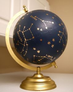 a blue and gold globe with stars on it sitting on top of a white counter