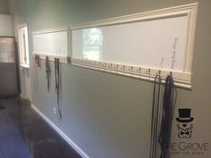 an office hallway with white walls and lots of magnets on the wall next to each other