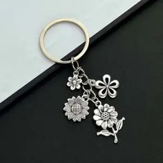 a metal key chain with flowers on it