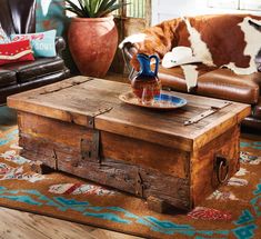 a living room with a cow statue on the coffee table