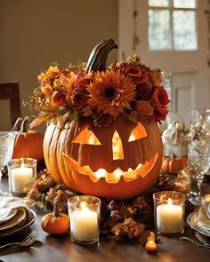 a table topped with pumpkins and candles