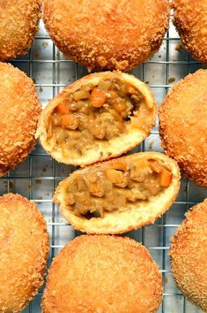 several pastries with meat in them on a cooling rack