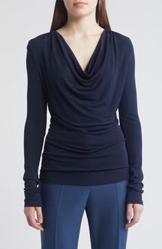 A draped neck creates lavish folds down the front of this knit top providing an intriguing counterpoint to the style's slim, figure-skimming fit. Cowl neck Long sleeves 100% viscose Machine wash, dry flat Imported Ruched Draped Top In Elastane, Ruched Draped Elastane Top, Chic Draped Elastane Tops, Elegant Ruched Foldover Top, Versatile Fitted Draped Top, Stretch Draped Tops, Draped Tops For Workwear In Fall, Draped Fall Tops For Workwear, Elegant Fine Knit Elastane Tops