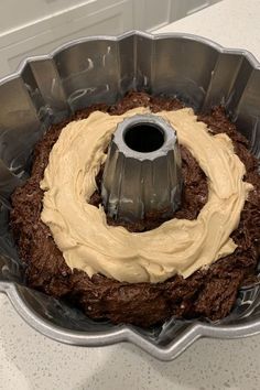 a cake in a metal pan with frosting on the top and bottom, ready to be baked