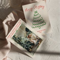 two christmas cards sitting next to each other