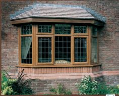 a brick building with three windows and a tiled roof