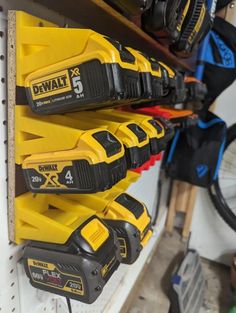 some yellow and black tools are hanging on the wall