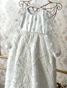 Cherish your little one's blessed moment with our exquisite white rose detailed Christening Gown with matching bonnet and shoes, a perfect blend of divine elegance and heartfelt tradition, hand crafted to create memories that will be treasured for a lifetime! This christening gown has been crafted entirely by hand, with meticulous attention to detail. ♥ If you want a custom design (in different color, size, fabric, model etc.), please contact us so we can create your dream piece together! * FABRIC: Lace, satin and cotton gentle with your baby's skin with its smooth texture. * LINING: 100% Organic Soft Cotton (pre-washed and ironed), ensuring utmost comfort for your little one throughout the ceremony. * DETAILS: Exquisite Cotton-Satin blend with intricately Exclusive Embroidered Lace belt a White Dress With Pearl Embroidery For Ceremony, White Ceremony Dress With Pearl Embroidery, White Pearl Embroidered Dress For Ceremony, White Floral Embroidered Baptism Dress, White Lace Baptism Dress With Floral Applique, White Embroidered Dress For Baptism, White Floral Embroidery Baptism Dress, Lace Baptism Dress With Embroidery For First Communion, White Baptism Dress With Floral Embroidery