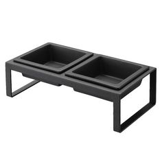 two black trays sitting on top of each other in front of a white background