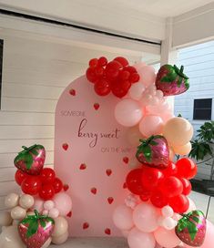 some balloons and strawberries on a table