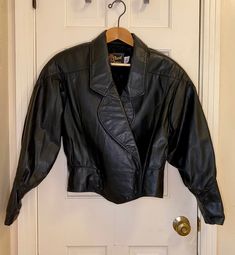 Gorgeous, heavy but soft, double-breasted, original from the 1980s black leather jacket. This jacket has the toughness of leather, but button it up and cinch that waist and its sleek too. This is old school leather - it makes noise when you move, it smells like leather, it's stiffer than modern leather jackets too. It's old and has creases and scuffs that make it look cool, but no issues. Woman's size medium. Feel free to ask questions. In need of more fun vintage? https://retroburgh.etsy.com Greaser Jacket, Vintage Black Leather Jacket, Studded Leather Jacket, Studded Jacket, Cropped Leather Jacket, Leather Jacket Black, Leather Motorcycle Jacket, Studded Leather, Black Leather Jacket