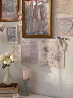 there are pictures on the wall with flowers and candles