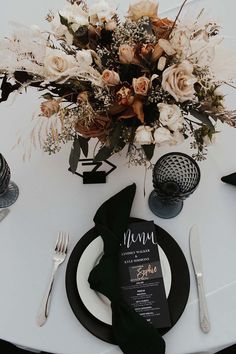 a table setting with flowers and silverware