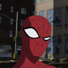 a spider - man is standing in front of some buildings and looking at the camera