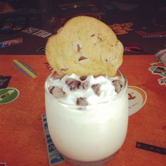 a cookie and cream dessert in a glass on a table