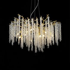 a chandelier with white beads hanging from it's center and black background