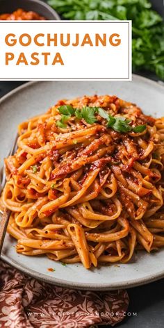 a plate full of spaghetti with sauce and parsley on the side text reads gochuuanng pasta